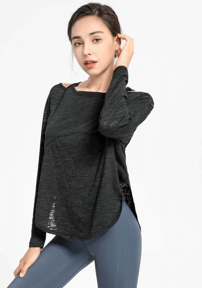 Woman wearing a stylish sporty lightweight women's top with long sleeves and cutouts, perfect for yoga and comfortable movement.